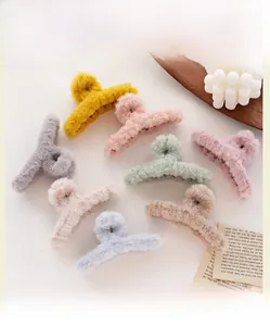 Detailed flat lay of soft plush hair claw clips in eight Morandi colors for hair styling