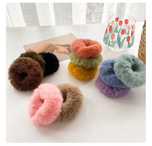 Detailed view of colorful plush faux fur hair ties in various soft pastel shades