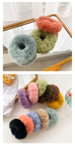 Close-up of soft faux fur scrunchies in multiple pastel colors with fluffy texture