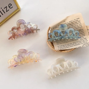 Elegant crown-shaped acetate hair claw clips with heart cutouts in pearlescent marble colors