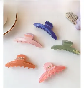 Set of five large candy-colored acetate hair claws in a stylish lifestyle arrangement