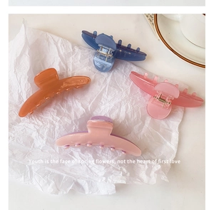 Set of four matte acetate hair claws in caramel, blue, pink, and lilac colors