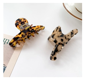 Close-up of large acetate hair claws in dark tortoise shell and light beige patterns