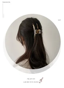 Elegant tortoiseshell acetate hair claw clip shown in a half-up hairstyle for women