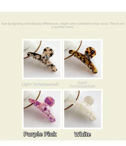 Detailed close-up of large acetate hair claws in tortoise shell and marble patterns