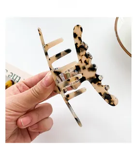 Close-up of elegant tortoiseshell large hair claw clip made of polished acetate