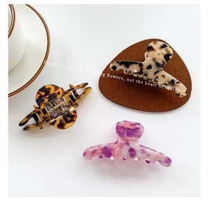 Close-up of elegant acetate hair claws in tortoiseshell and marble patterns