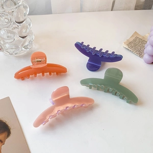 Minimalist acetate candy colored hair claws in orange, purple, green and pink colors