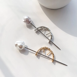 Minimalist curved metal hair pin with baroque pearl in gold and silver finishes