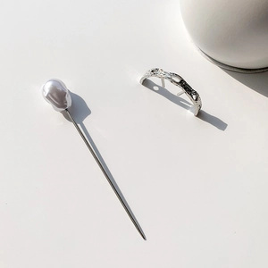 Minimalist silver curved hairpin with baroque pearl and natural rock texture