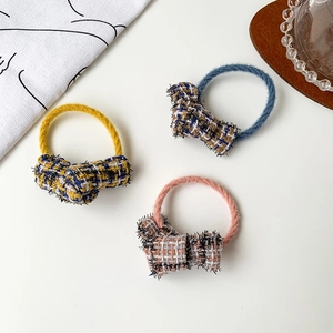 Three-piece set of elegant tweed bow hair ties in yellow, blue and pink colors