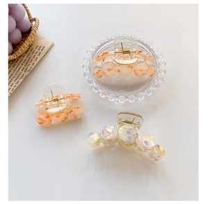 Detailed set of French style acetate floral hair claws with amber textures and beads