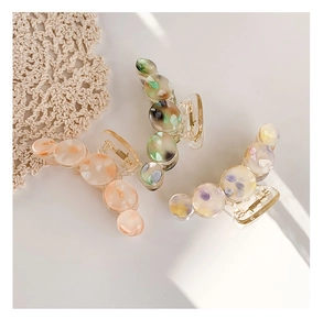 Three-piece acetate shark hair claws with colorful fragments on a lace background