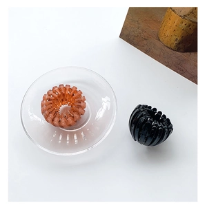 Bird nest shaped hair claw clips in amber and black finish with expandable resin design
