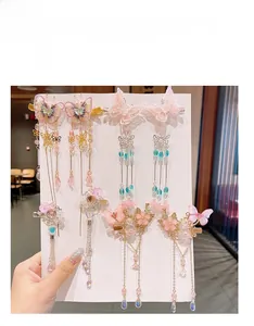 Détails des barrettes papillon à glands avec broderie et perles artificielles