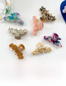 Collection of large colorful acetate shark hair claws with various marble and floral patterns