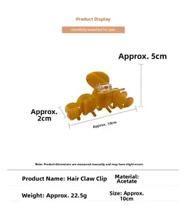 Macro detail of amber yellow acetate hair claw clip showing 10cm length and glossy texture