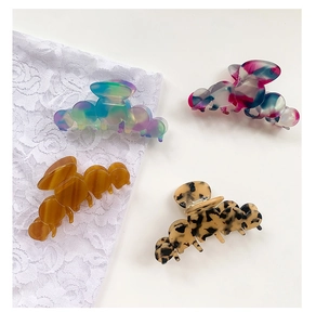 Macro detail of large acetate hair claws in various marble and tortoiseshell patterns