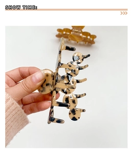 Detail shot of a large tortoiseshell resin shark hair claw clip showing side texture