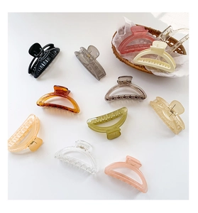 Detailed collection of assorted colorful glossy plastic crescent hair claws for styling
