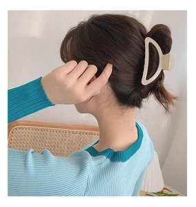 Creamy crescent hair claw clip on model showing minimalist style for bun hairstyle