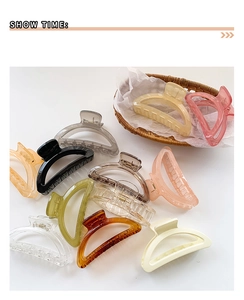 Collection of large crescent hair claws in multiple colors shown on a white background
