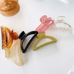 Set of six large crescent-shaped resin hair claws in assorted colors on a white surface