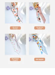 Détail de divers foulards en soie avec des motifs de fruits comme l'orange et la pêche