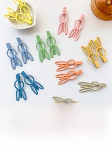 Close-up of matte candy-colored rabbit ear hair clips in various pastel macaron shades