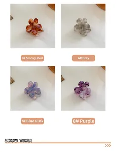 Detailed view of four acetate floral hair claws in red, grey, blue-pink, and purple