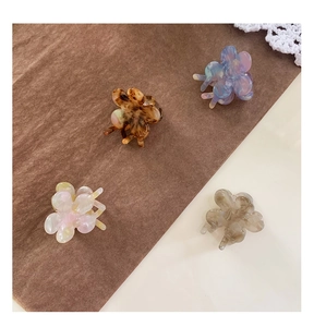 Set of four mini acetate flower hair claws in amber, purple, pink and grey colors