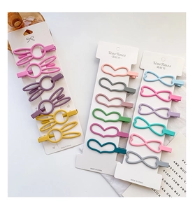 Close-up of matte pastel bunny and heart hair clips on white display cards
