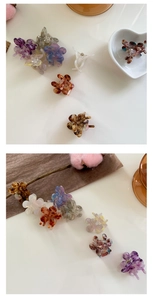 Detailed macro view of small acetate flower hair claws with elegant marble textures