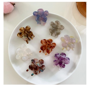 Detailed macro view of 8-piece mini acetate flower hair clips with marble patterns