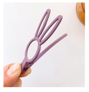 Detail of purple matte bunny ear hair clip made of ABS plastic with a secure duckbill grip