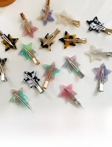 Macro detail of various acetate star hair clips with leopard and marble patterns
