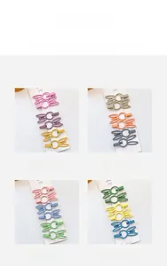 Detail view of colorful matte rabbit ear hair clips on heart patterned cards