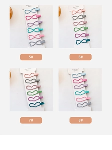 Matte candy-colored rabbit ear hair clips in heart and infinity shapes on display cards