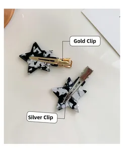 Detail view of star hair clips showing gold and silver metal alligator clip backings