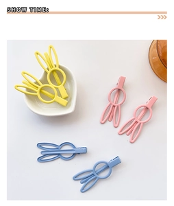 Detail view of cute bunny ear hair clips with matte finish in various candy colors