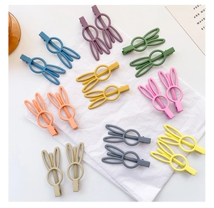 Detail view of colorful matte bunny ear hair clips in eight sweet candy shades