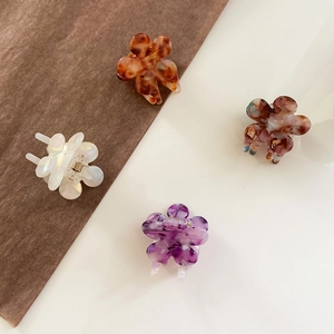 Set of four flower acetate hair claws with marble and tortoiseshell patterns in diverse colors