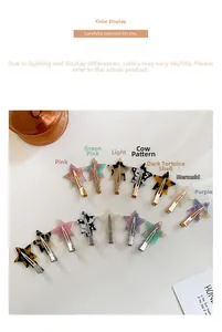 Flat lay of colorful star-shaped acetate hair clips with gold metal duckbill clips