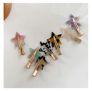 Detailed macro view of colorful marble-textured star acetate hair clips for women