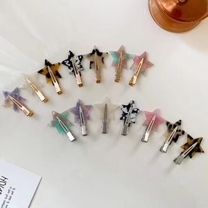 Set of 14 star-shaped acetate hair clips with marble patterns and metal duckbill clips