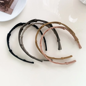 Macro view of four colorful folding headbands showing non-slip teeth and hinge details