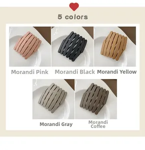 Collapsible matte finish headbands in five Morandi colors on elegant ceramic plates