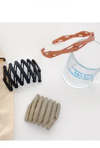 Detail view of foldable telescopic hair bands in black, khaki, and peach pink colors
