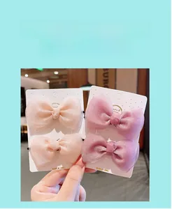 Close-up of pink layered mesh bow hairpins for girls with fine shimmering texture