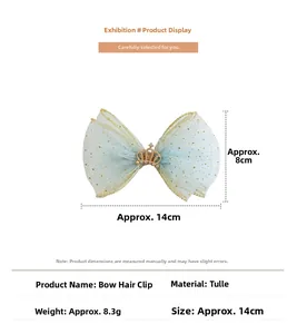 Detail of light blue mesh bow hair clip with gold crown, dimensions 14cm by 8cm
